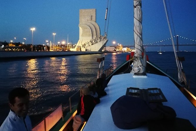 2-Hour Lisbon Traditional Boats Sunset Cruise with White Wine - The 25 de Abril Bridge pass: photo time and wind reality