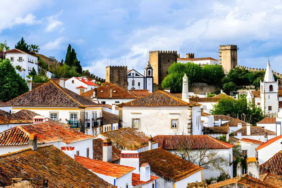 From Lisbon: Obidos, Nazaré and Fátima Small Group Tour - Óbidos: walking the castle walls and tasting the town’s signature ginjinha