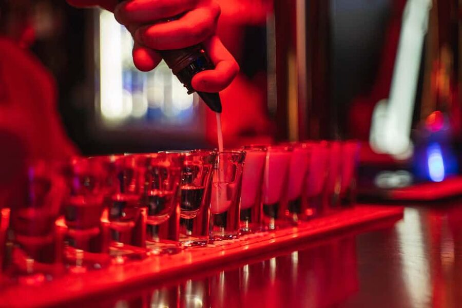 Lisbon: Drunken History Walking Tour with Included Drinks - Bairro Alto after dark, with Portuguese drinks and scandal stories